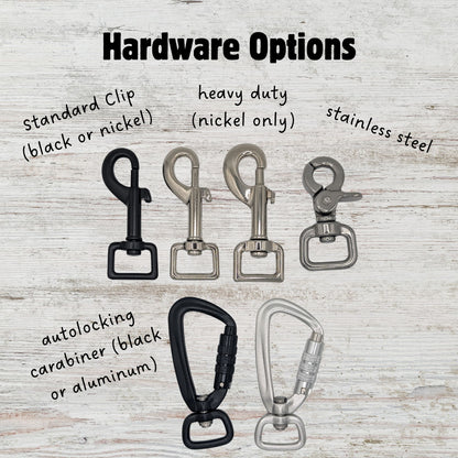 Different types of dog leash hardware shown laying flat on a light woodgrain background. Picture are: standard style clips in black and nickel, a heavy duty version in nickel, a stainless steel option, and an autolocking carabiner in both black and aluminum.