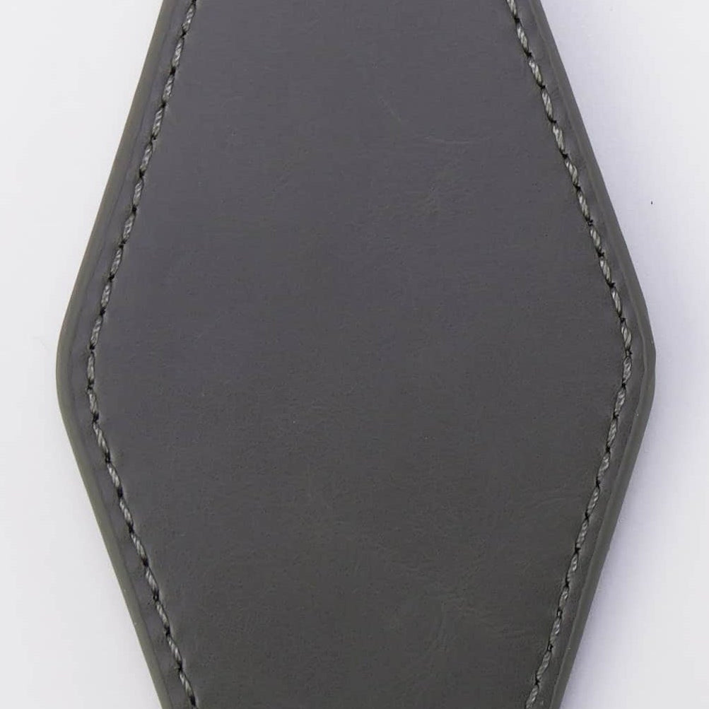 Gray leather keychain on a white background