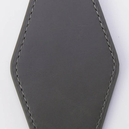 Gray leather keychain on a white background