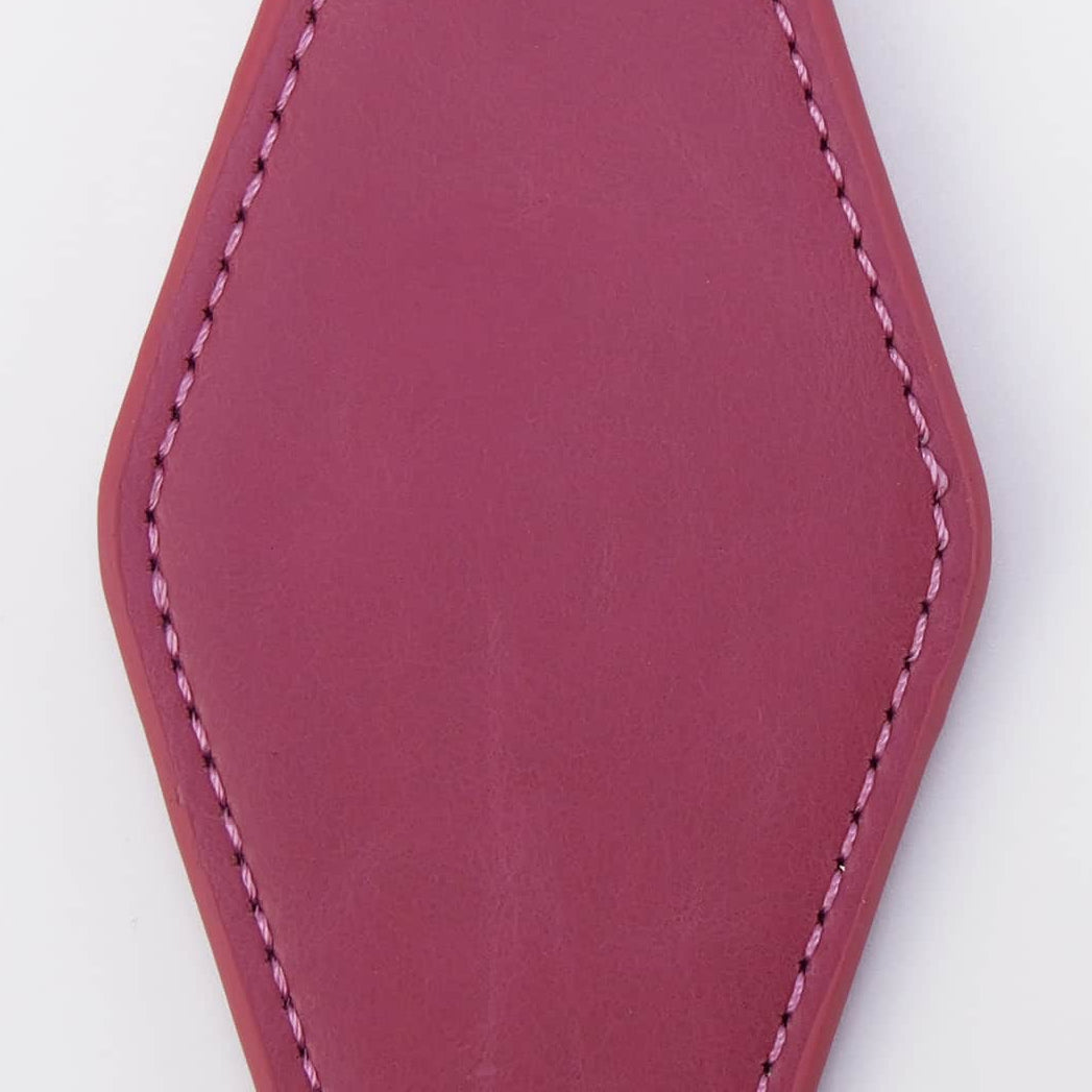 A magenta leather keychain tag with a stitched border, attached to a black metal clasp and a silver split key ring, shown on a plain white background.