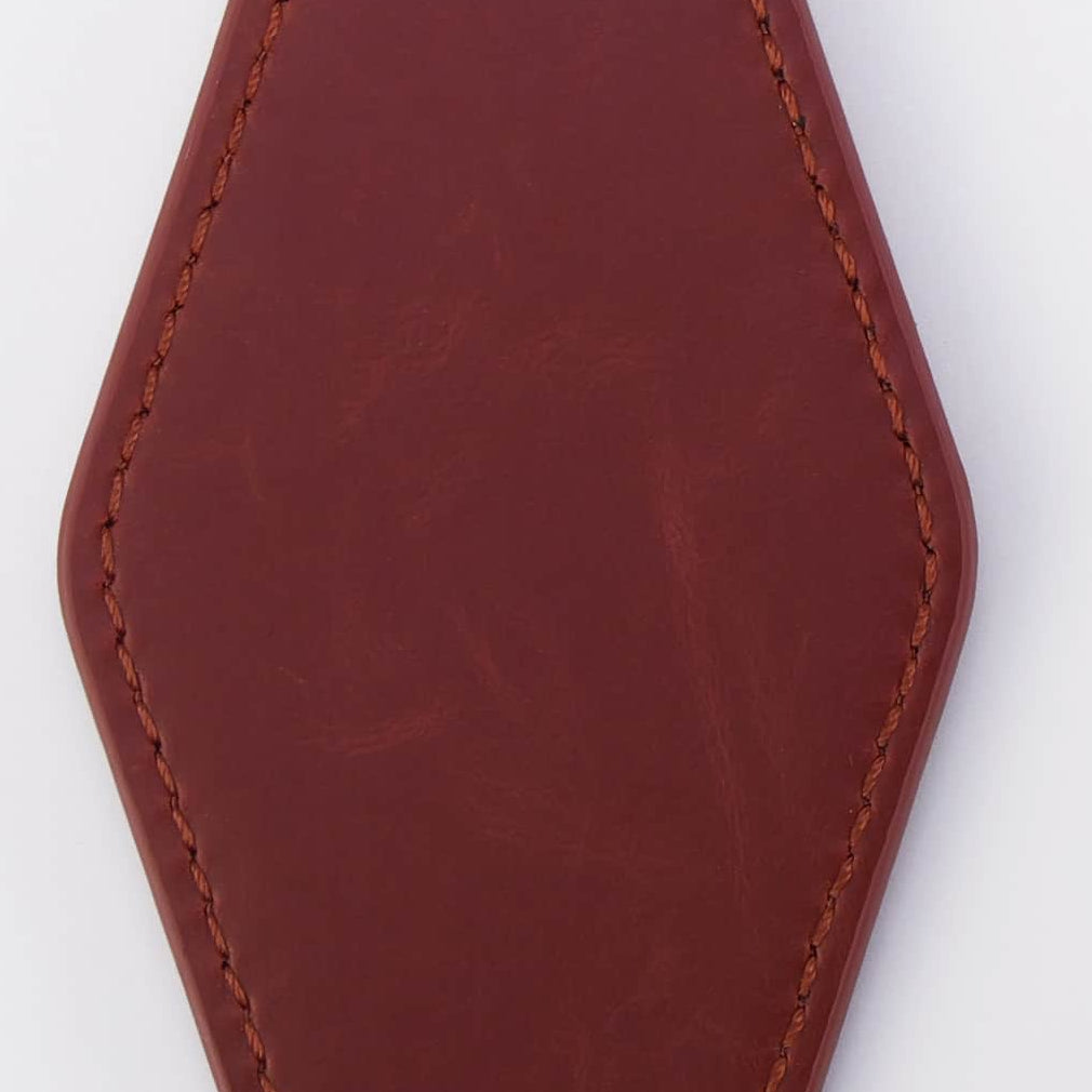 Dark red leather keychain with metal ring on a white background
