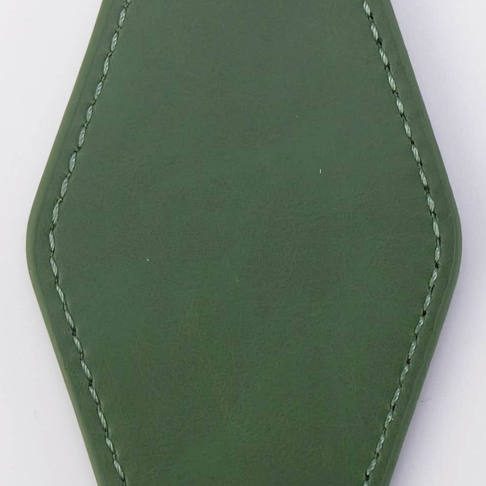 An olive green faux leather keychain tag with white contrast stitching, attached to a black metal carabiner and two silver key rings, shown on a plain white background.