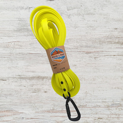 Yellow long line style leash with an autolocking carabiner featuring rescue and roam branded packaging 