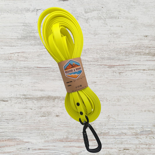 Yellow long line style leash with an autolocking carabiner featuring rescue and roam branded packaging 