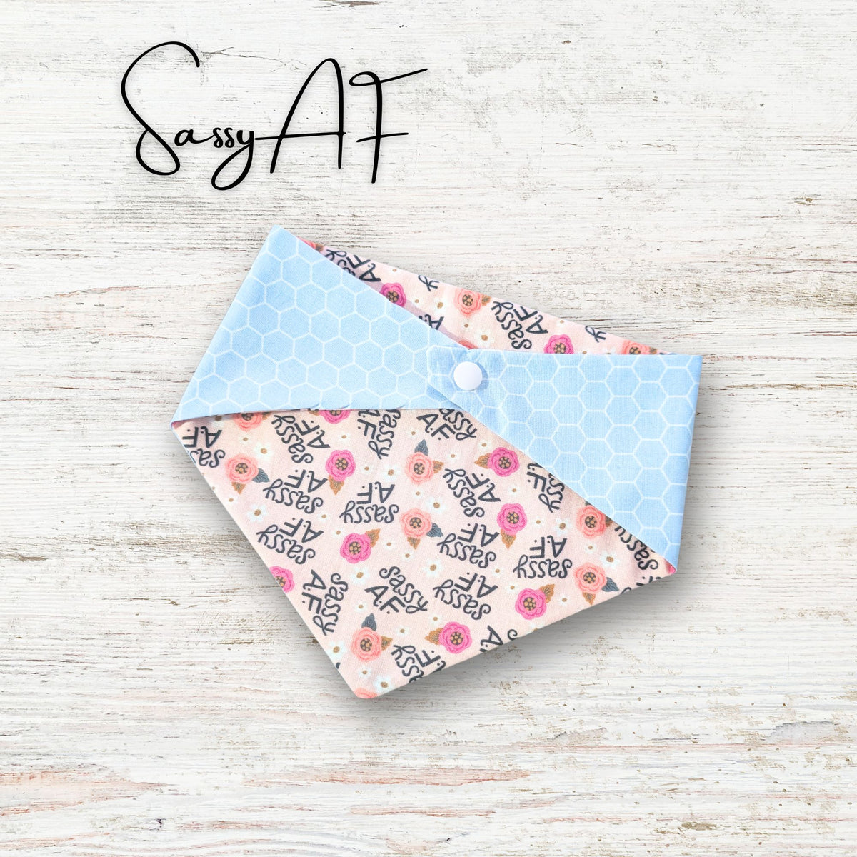 Floral patterned fabric bandana on a light wooden surface with 'Sassy AF' text above.