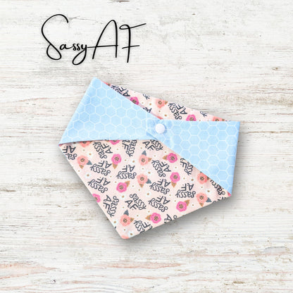 Floral patterned fabric bandana on a light wooden surface with 'Sassy AF' text above.