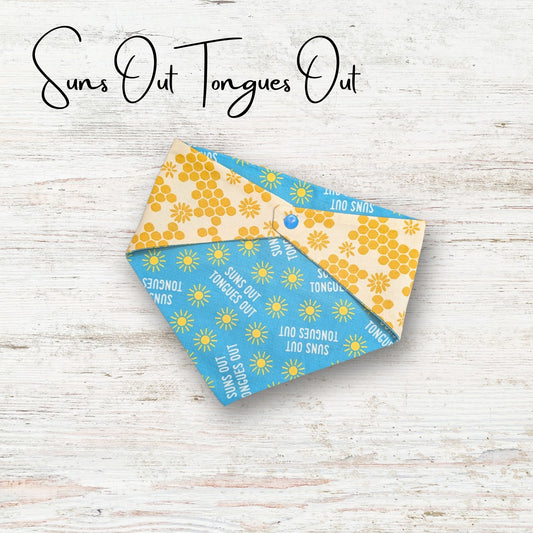 Two bandana styles with 'Suns Out Tongues Out' text on a light wooden surface.