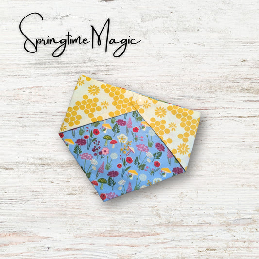 Floral patterned fabric pet bandana on a wooden surface with 'Springtime Magic' text.